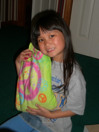 Kasen with her peace sign towel and bag